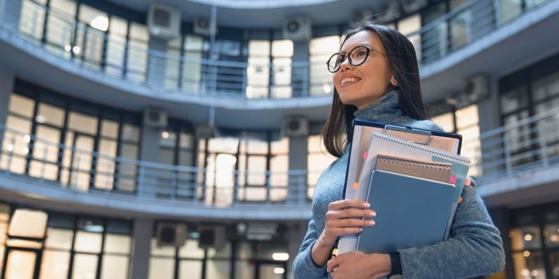 horizontal shot of smiling business woman standing