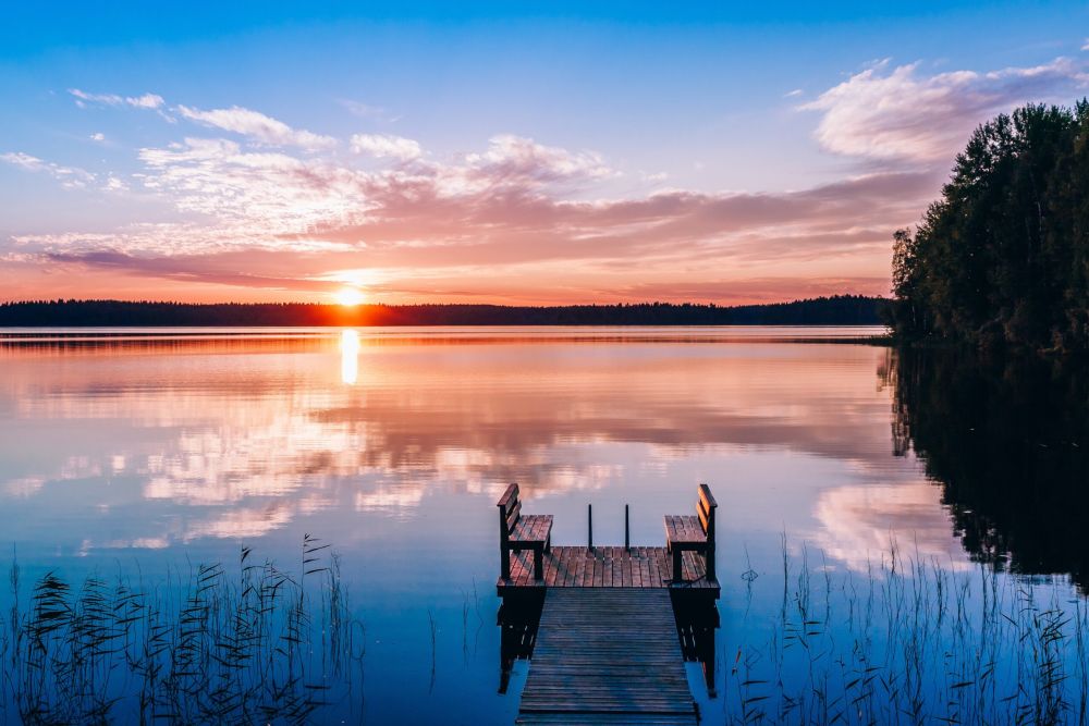 idyllic-view-of-the-long-pier-with-wooden-bench
