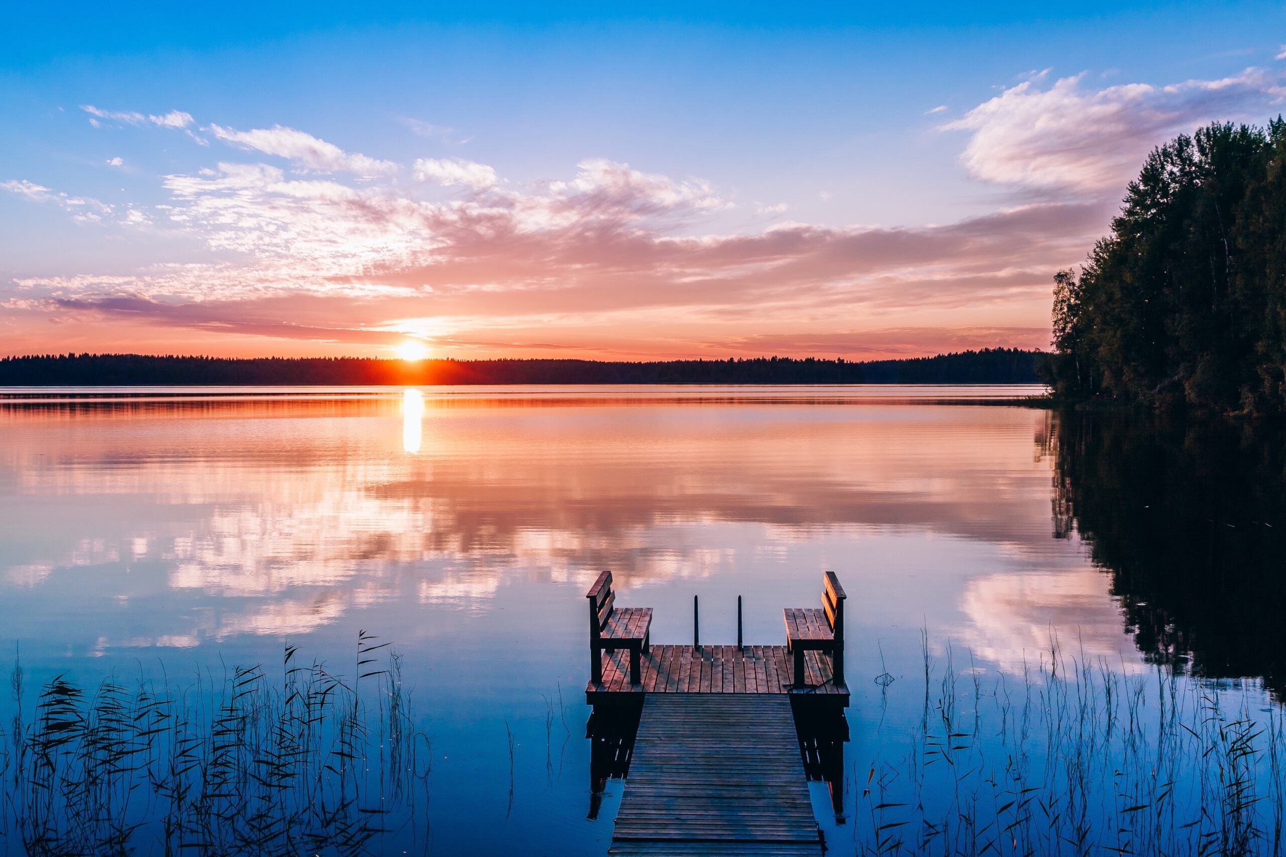 idyllic-view-of-the-long-pier-with-wooden-bench
