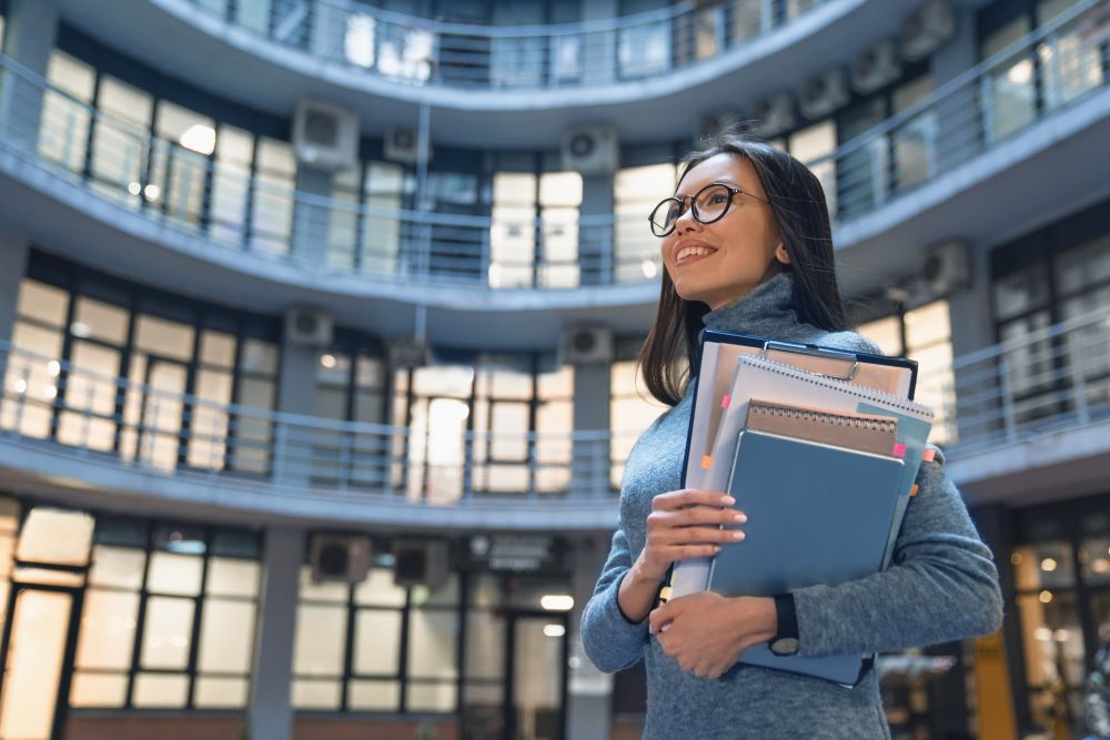 horizontal shot of smiling business woman standing
